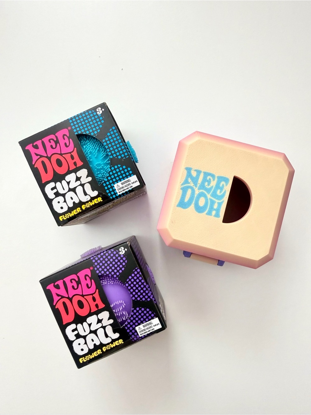 NeeDoh flower power fuzz ball with rainbow glow in the dark case